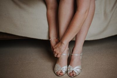 closeup shot female tying her white shoes 181624 1562